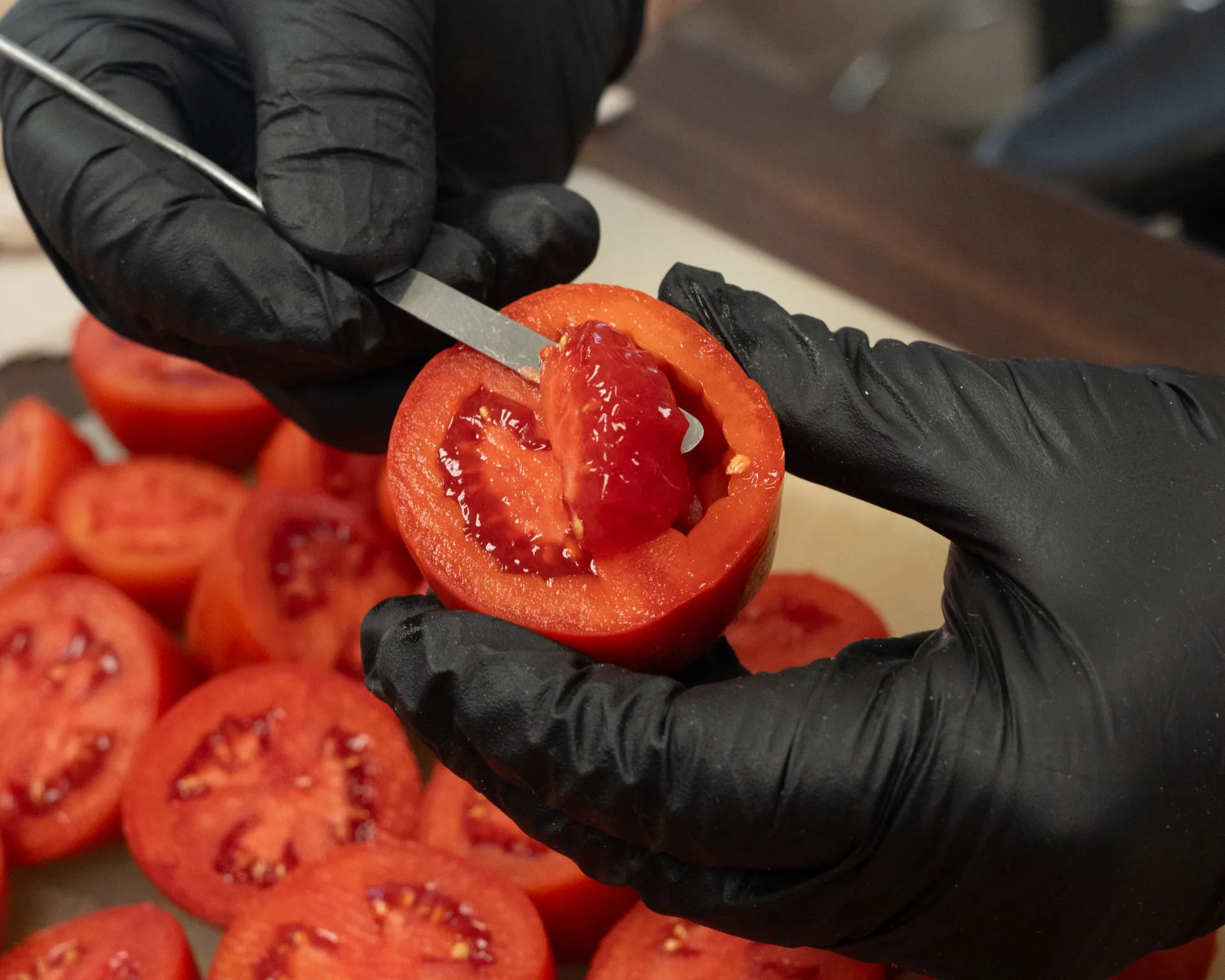 Tomato fruit cut open for interior evaluation — wall thickness, locule, seed count